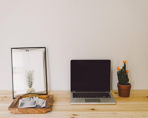 A well-lit cozy home office setup near a window